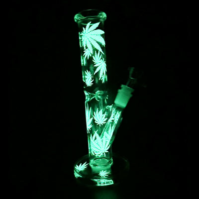 A glow-in-the-dark didgeridoo with a leaf pattern, featuring a white body and green leaves, with a small light on the top for illumination.
