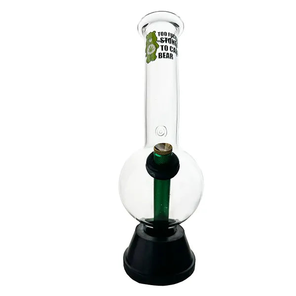 A transparent glass bong with a green stem and a bear-themed label on the top, standing on a black base.