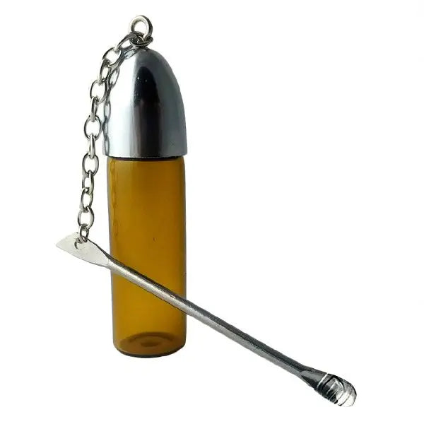A yellow glass vial with a silver spoon attached to the lid with a chain.