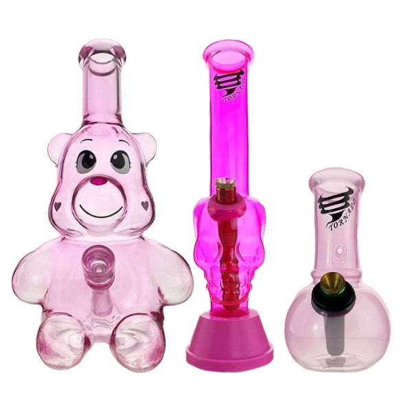 Set of pink glass smoking accessories including a bear-shaped bong and two other pipes on a white background.