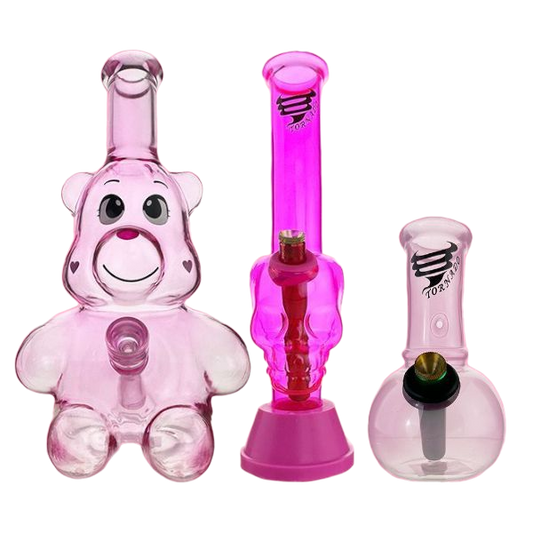 Set of pink glass smoking accessories including a bear-shaped bong and two other pipes on a white background.