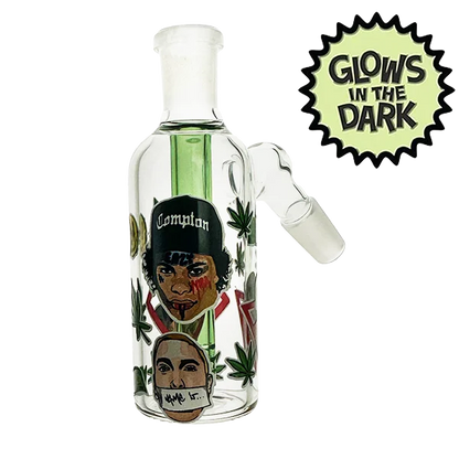 Glass smoking device with artistic design and 'Glow's in the Dark' label on a white background