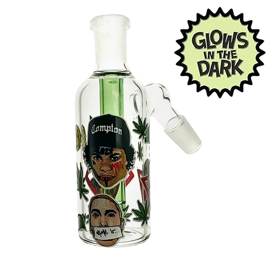 Glass smoking device with artistic design and 'Glow's in the Dark' label on a white background