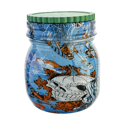 Jar grinder with a skull design and blue and with a green lid.