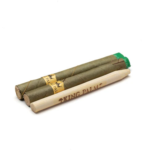 Three King Palm rolling papers with a green band on a white background